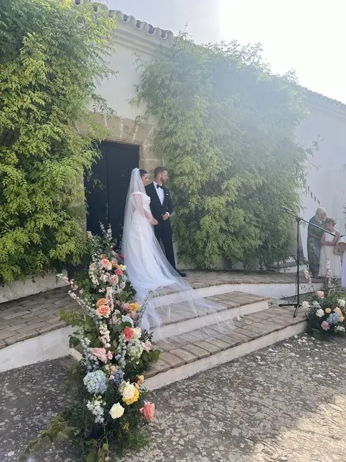 Bride and groom on steps with flower decorations